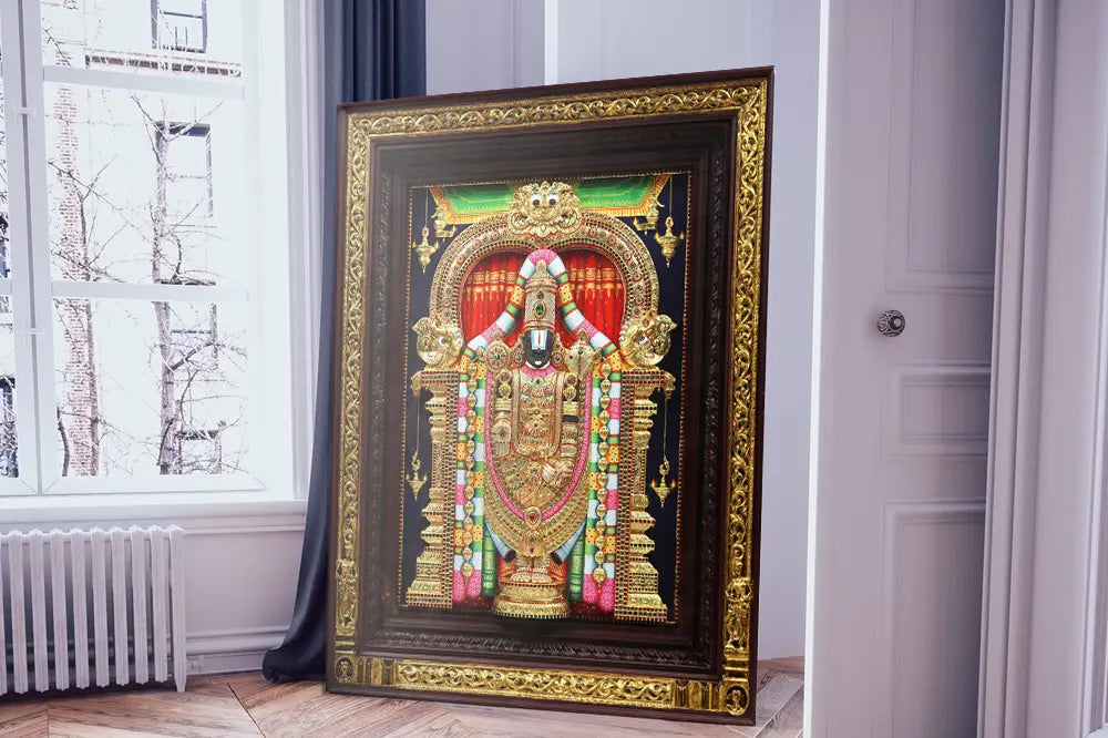 Artist applying 22-karat gold leaf onto a Tanjore painting of Goddess Lakshmi — Sacred South Indian Art | Moksha Craft
