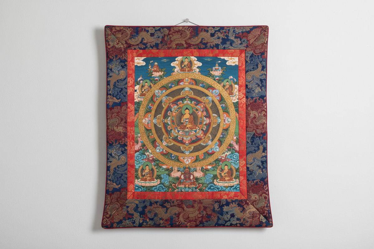 Tibetan Thangka painting — intricate Buddhist mandala with gold and red pigments, silk brocade border | Moksha Craft